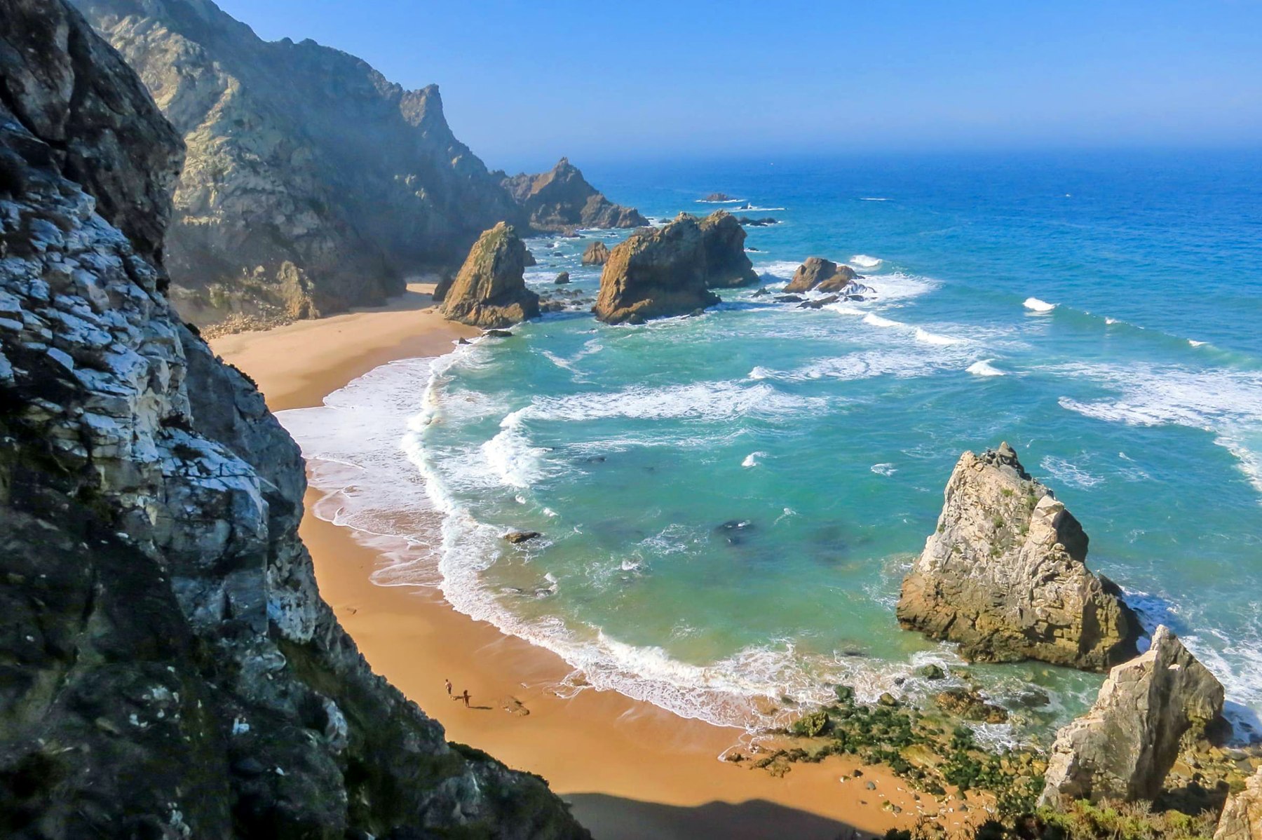 Sea stacks and turquoise Atlantic water at Praia da Ursa